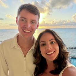 Zach and his wife at sunset over the ocean
